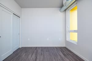 Bedroom with hardwood floors and large window at 459 Rock Apartments, 459 SE 192nd Ave, Gresham, Oregon 97233