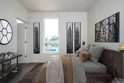Staged bedroom with large window at 459 Rock Apartments