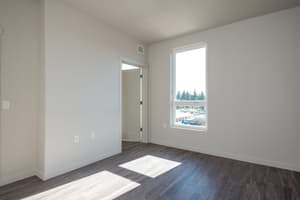Bedroom with large window and hardwood floors at 459 Rock Apartments, 459 SE 192nd Ave, Gresham, Oregon 97233