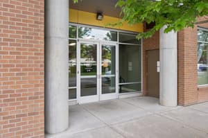 Exterior with glass doors, brick walls at 459 Rock Apartments, 459 SE 192nd Ave, Gresham, Oregon 97233