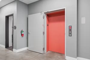 Hallway with elevator access, fire extinguisher at 459 Rock Apartments, 459 SE 192nd Ave, Gresham, Oregon 97233