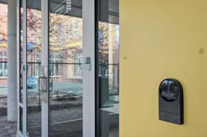 Exterior with glass doors, yellow wall at 459 Rock Apartments, 459 SE 192nd Ave, Gresham, Oregon 97233
