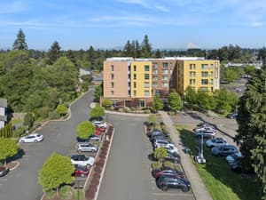 Aerial with parking lot, landscaped trees at 459 Rock Apartments, 459 SE 192nd Ave, Gresham, Oregon 97233