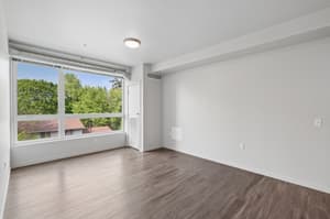 Bedroom with large window, hardwood floors at 459 Rock Apartments, 459 SE 192nd Ave, Gresham, Oregon 97233