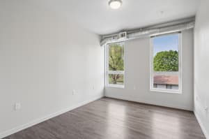 Bedroom with large windows, hardwood floors at 459 Rock Apartments, 459 SE 192nd Ave, Gresham, Oregon 97233