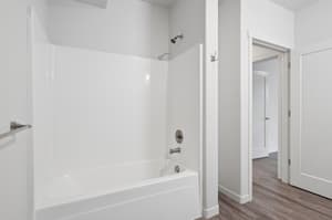 Bathroom with bathtub shower combo, white fixtures at 459 Rock Apartments, 459 SE 192nd Ave, Gresham, Oregon 97233