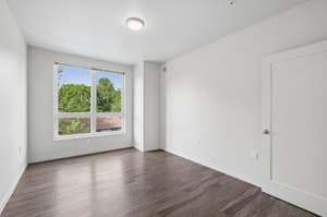 Bedroom with large window, hardwood floors at 459 Rock Apartments, 459 SE 192nd Ave, Gresham, Oregon 97233