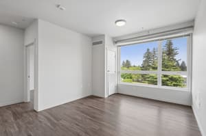 Bedroom with large window, hardwood floors at 459 Rock Apartments, 459 SE 192nd Ave, Gresham, Oregon 97233
