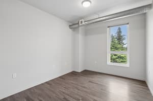 Bedroom with hardwood floors, large window at 459 Rock Apartments, 459 SE 192nd Ave, Gresham, Oregon 97233