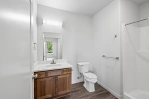 Bathroom with wood cabinetry, modern lighting at 459 Rock Apartments, 459 SE 192nd Ave, Gresham, Oregon 97233