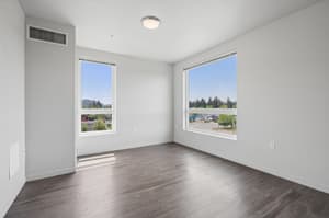 Two-bedroom apartment bedroom with large windows at 459 Rock Apartments