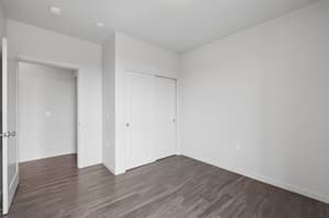 Bedroom with sliding closet doors, hardwood floors at 459 Rock Apartments, 459 SE 192nd Ave, Gresham, Oregon 97233