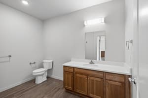 Bathroom with wood cabinetry, large mirror at 459 Rock Apartments, 459 SE 192nd Ave, Gresham, Oregon 97233