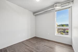Bedroom with large window, hardwood floors at 459 Rock Apartments, 459 SE 192nd Ave, Gresham, Oregon 97233